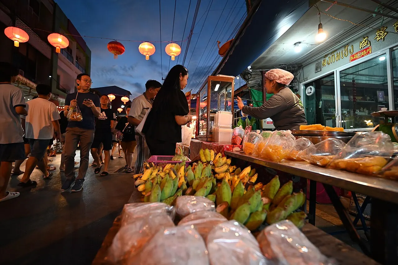 Locals browsing the food stalls at an evening market